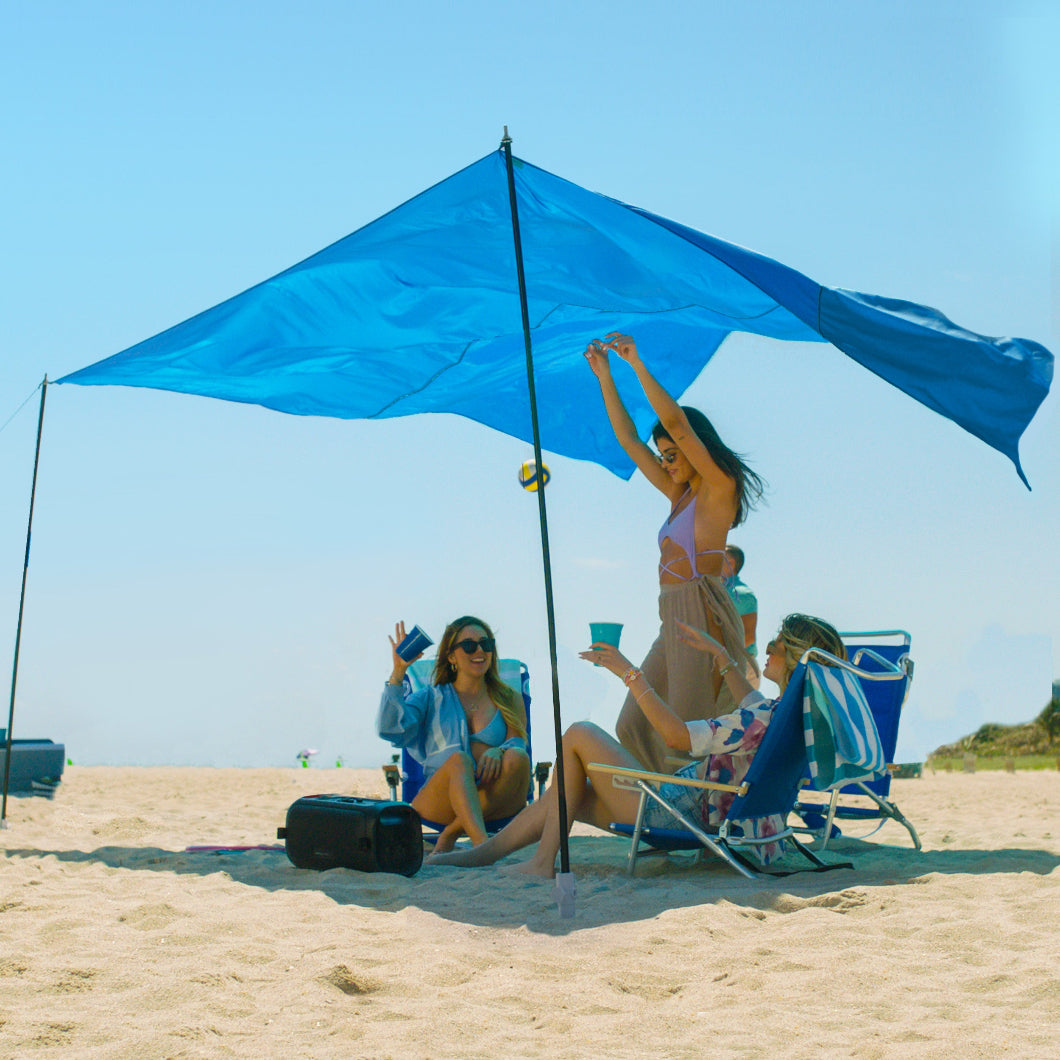 AMMSUN light blue beach shade on the sandy beach shade canopy wind sail, providing shade for three people