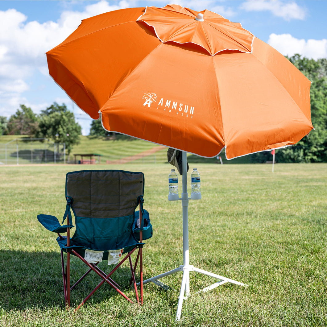 A chair under AMMSUN 6.5ft orange portable umbrella for outside umbrella on a field, providing patio shades