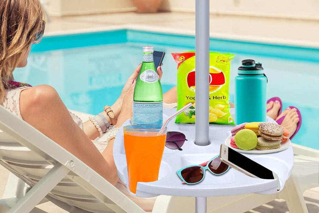 A woman relaxes in a chair by the pool, enjoying a drink and snacks on AMMSUN 17