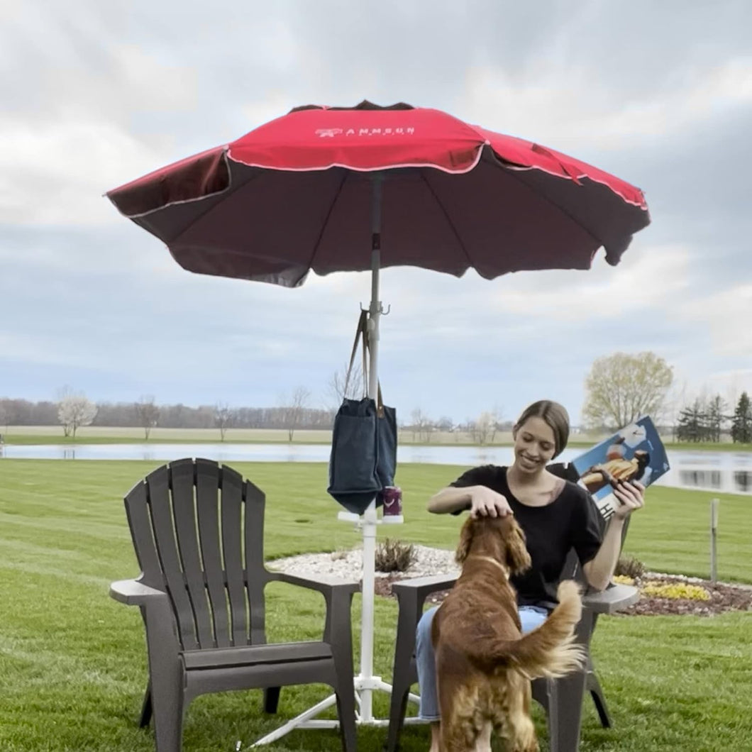 A woman enjoys her time in a lawn chair, sheltered under AMMSUN 6.5ft vibrant red patio umbrella with base