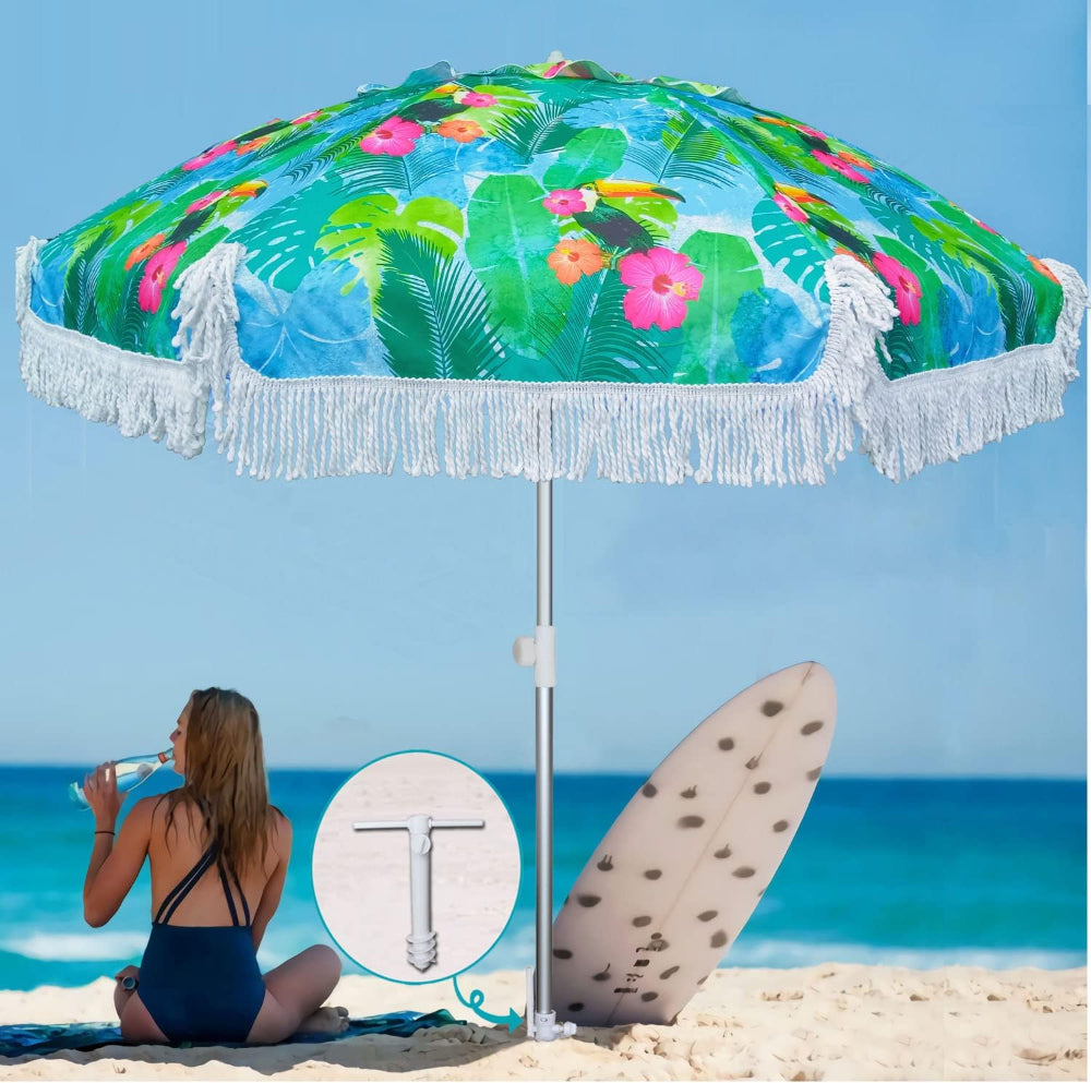 A woman relaxes on the beach under an AMMSUN 6.5ft tropical fringe beach umbrellas for sand portable with sand anchor