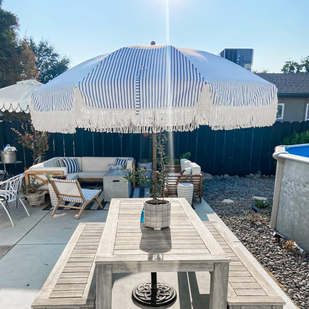 AMMSUN 7ft white and blue striped fringe garden umbrella for patio umbrella table is positioned on a table