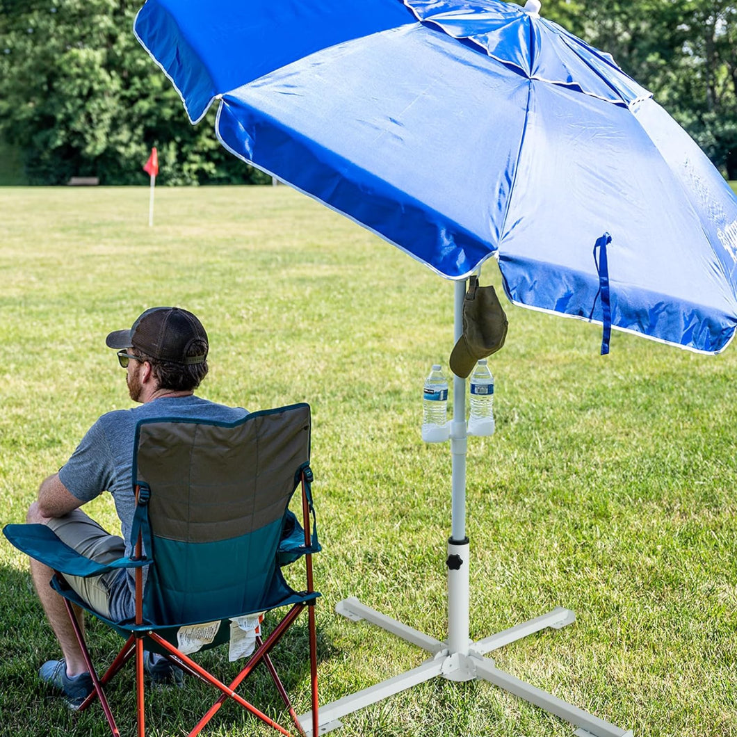 A man sits umder AMMSUN blue portable sports umbrella secured by AMMSUN white four folding legs stand