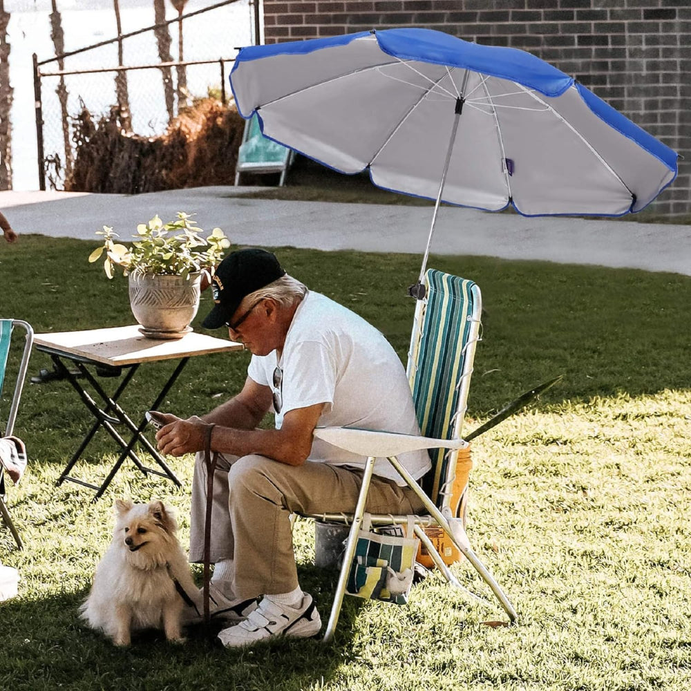 A men sitting on a chair shaded by an AMMSUN blue 43 inches chair umbrella secured to the chair by umbrella chair clamp