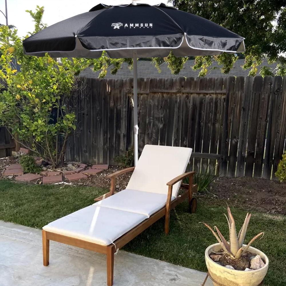 A stylish chaise lounge shaded by an AMMSUN 6.5ft black wind proof beach umbrella for patio outdoor master beach umbrella