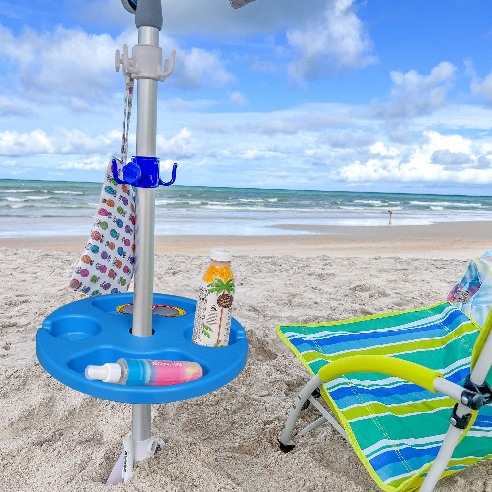 A chair on the beach is shaded by an umbrella with AMMSUN 13