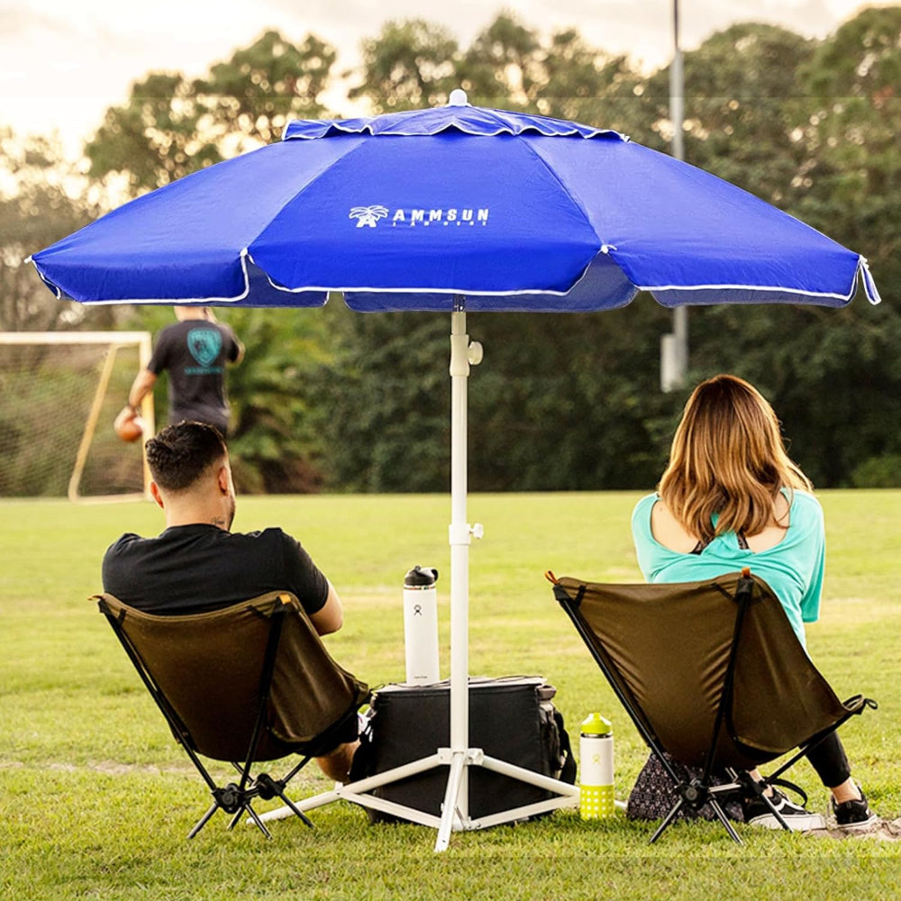 A couple sitting under a blue AMMSUN 6.5ft sombrillas de patio portable beach umbrella with base