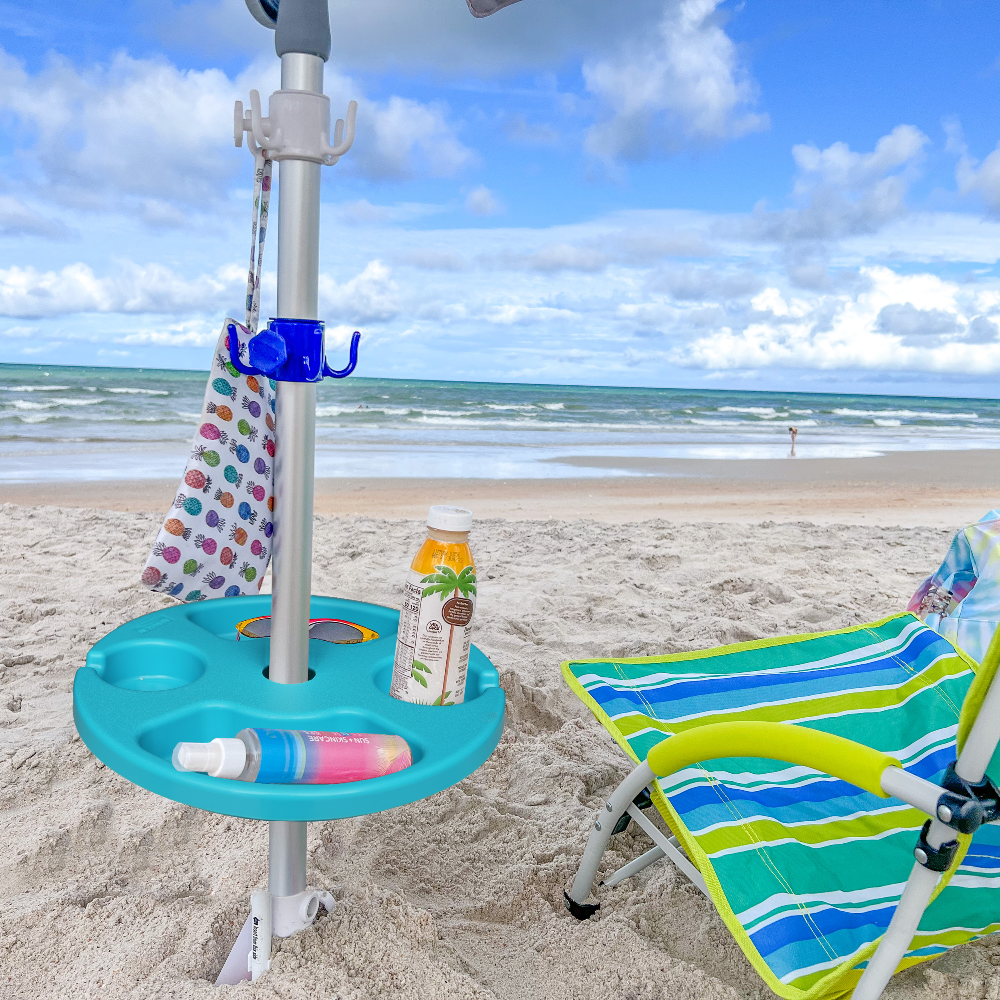 An umbrella on the beach with AMMSUN hanging hooks and 13