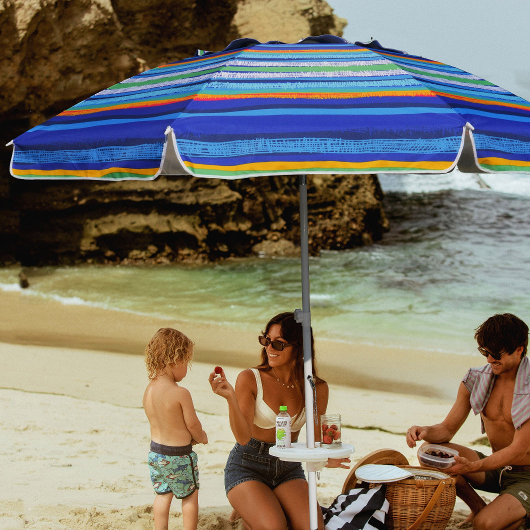 A family of three having relaxing under AMMSUN 8ft large size green Strips beach umbrellas with sand anchor