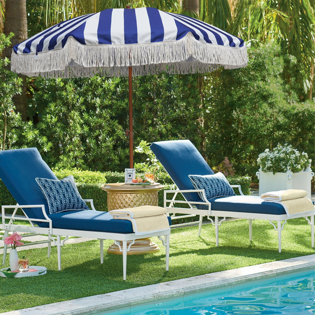 AMMSUN 7ft Blue Strips fringe patio table umbrella with tassel is prviding shade for two chairs nearby the pool