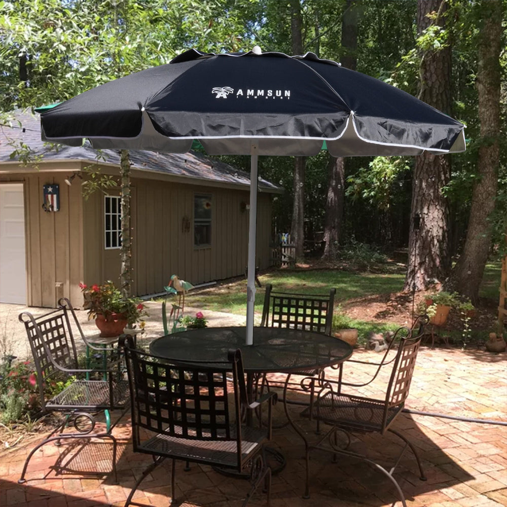 A charming outdoor scene with a table and chairs beneath an AMMSUN 6.5FT black outdoor umbrellas for patio