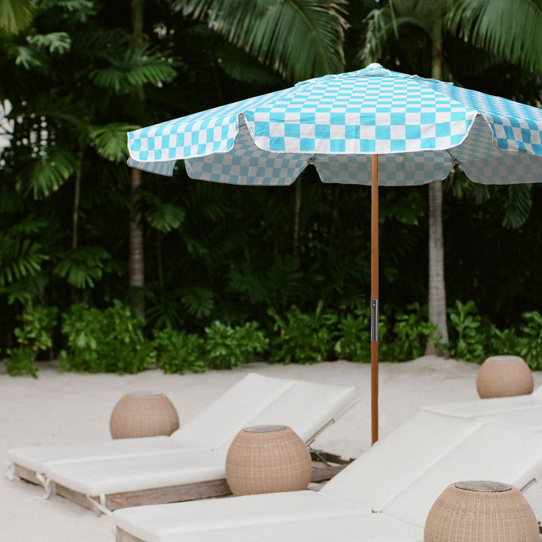 AMMSUN 7.8ft light blue check, white wind resistant beach umbrella stands tall against the backdrop of a sunny beach