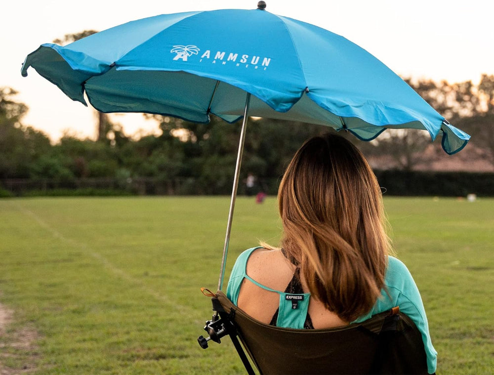 A woman seated in a chair with AMMSUN 43 inches chair umbrellas outdoor with clamp, Bright Blue beach umbrella for chair