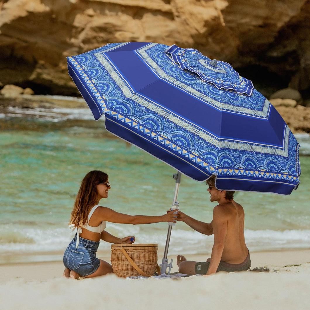 A man and a woman are relaxing umder AMMSUN Revival Blues 7ft heavy duty umbrellas for rain with anchor on beach