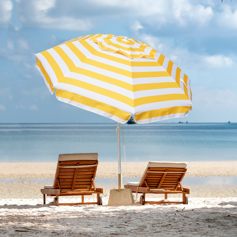 Two chairs positioned beneath a multicolor Yellow AMMSUN 6.5ft beach umbrellas for sand, providing shade