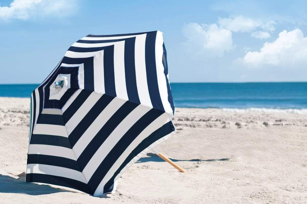 AMMSUN 7.5ft navy stripes heavy duty commercial grade travel umbrella with air vent ash wood pole is oppened on beach