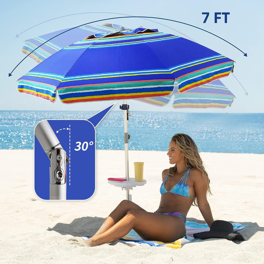 A woman is lying on a beach chair under AMMSUN 7ft multicolor blue beach umbrella with stand tilted at 30° on beach 