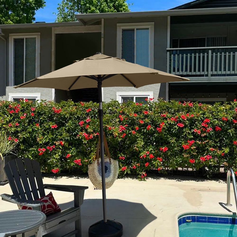 AMMSUN 6ft tan outdoor patio umbrellas clearance and a chair positioned beside a serene pool