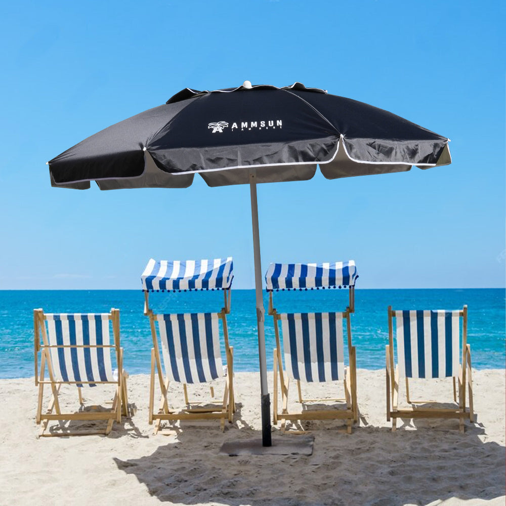 A sunny beach scene featuring colorful chairs and a large AMMSUN 6.5ft black beach umbrella