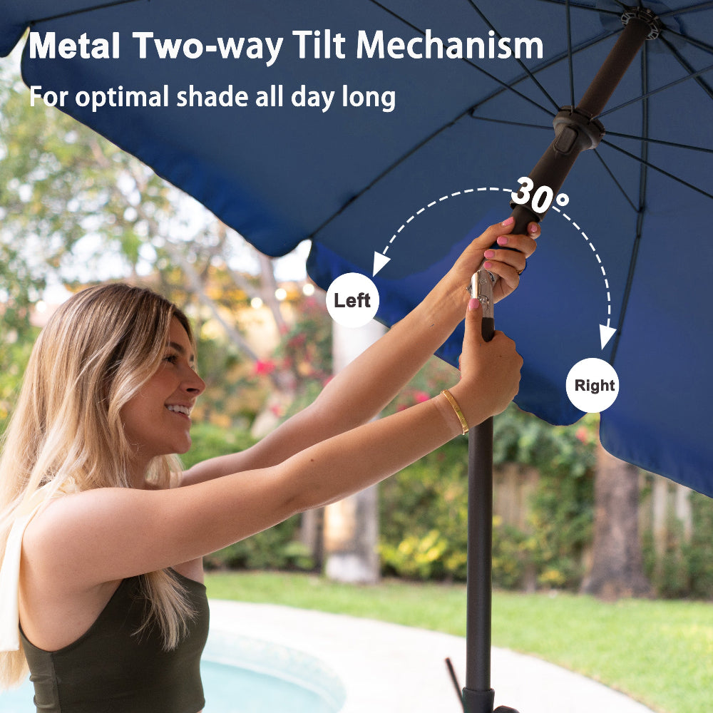 A woman is using the tilt button to adjust the AMMSUN 6.5ft navy blue umbrellas for patio to a 30° angle