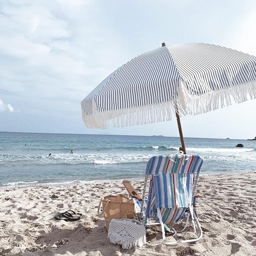 A beach chair and AMMSUN 7FT blue stripes portable beach umbrella with fringe sombrilla para patio