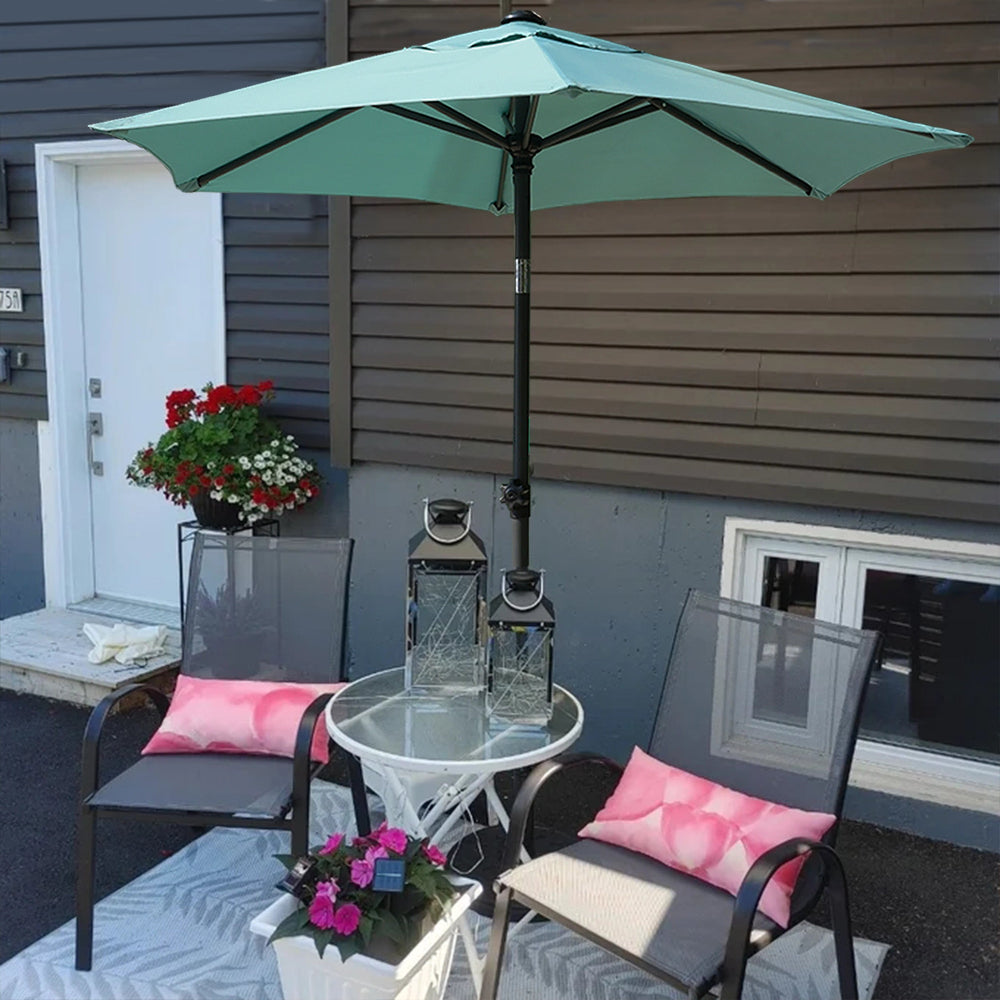 Outdoor patio scene with a table, several chairs, and an AMMSUN 6ft green umbrellas for rain