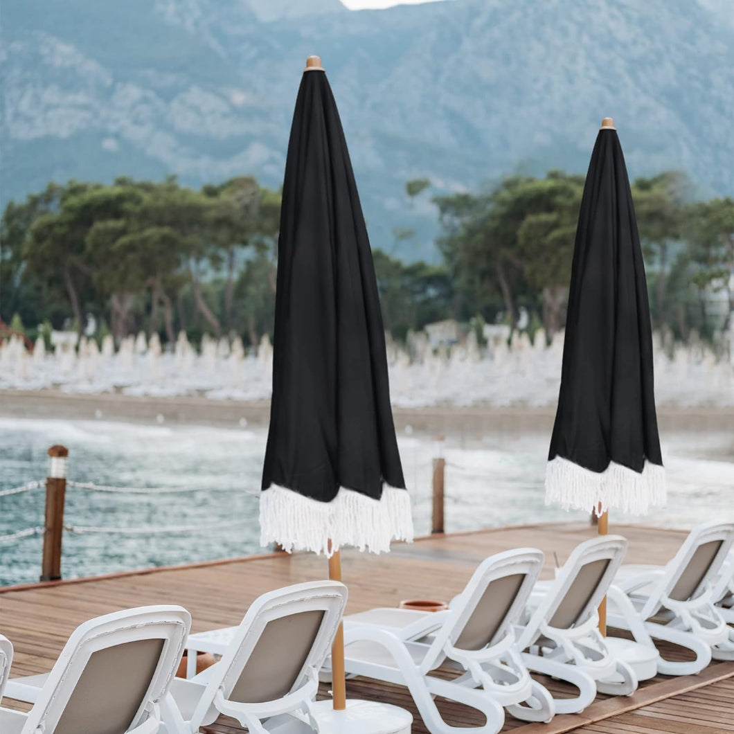 Two AMMSUN 7ft Noble Black patio table umbrella with fringe pool umbrella arranged neatly on a wooden pier