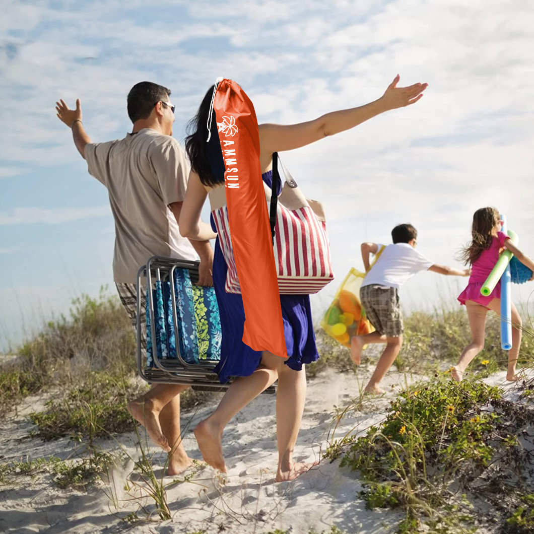 A family of four joyfully walks along the beach, carrying AMMSUN 6.5ft orange lightweight umbrella in carrying bag