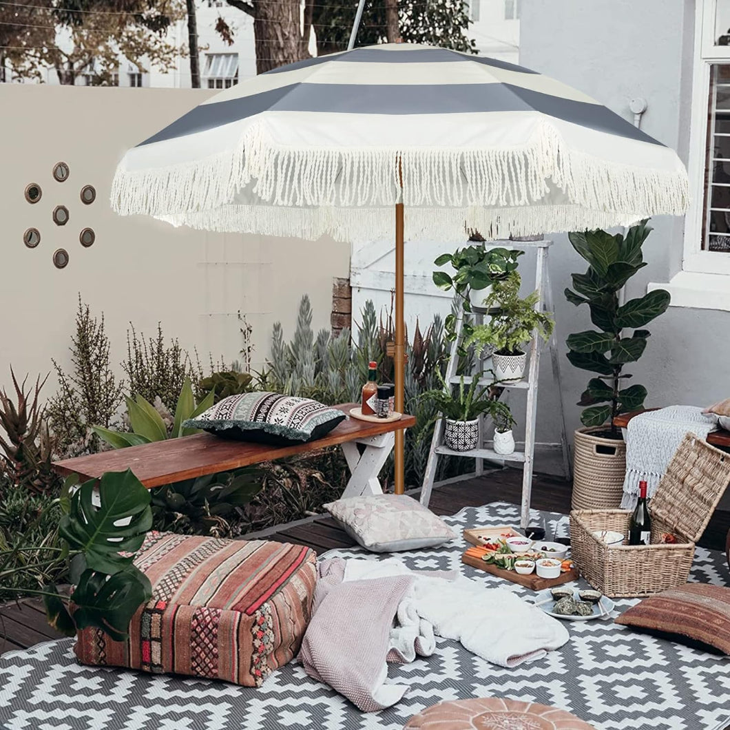 Outdoor patio scene with a table and an AMMSUN grey stripes 7ft large porch umbrella with fringe sun umbrella patio