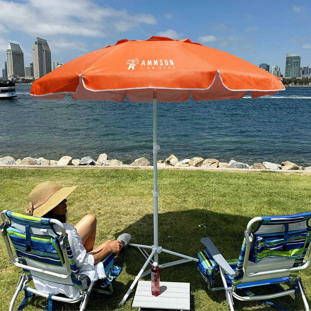 A woman sits comfortably in a lawn chair under AMMSUN 6.5ft orange portable umbrella with stand