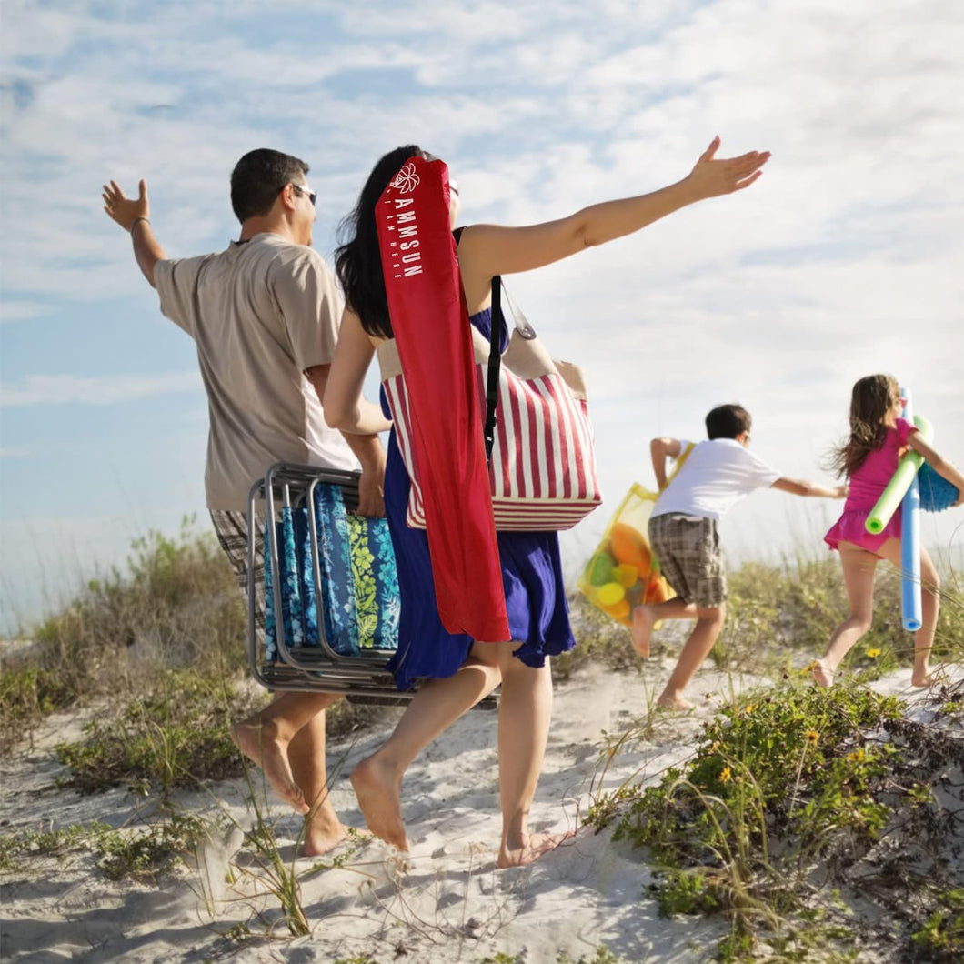 A family of four strolls along the beach, carrying AMMSUN 6.5ft portable lightweight umbrella in carrying bag