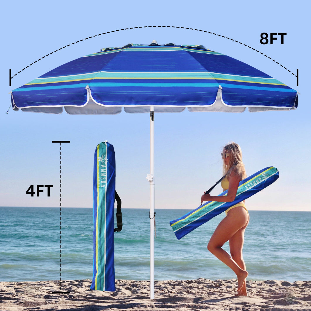 A woman is walking on the beach with 4ft long carrying bag for AMMSUN 8ft blue stripes portable umbrella with sand anchor