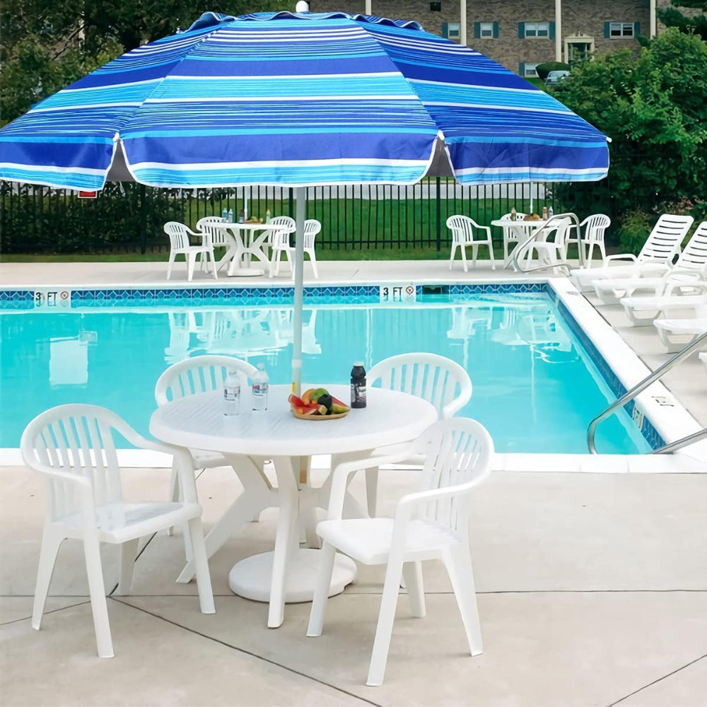 A blue striped AMMSUN 6.5ft mini poolside umbrella for sun protection uv provides shade over a table and chairs