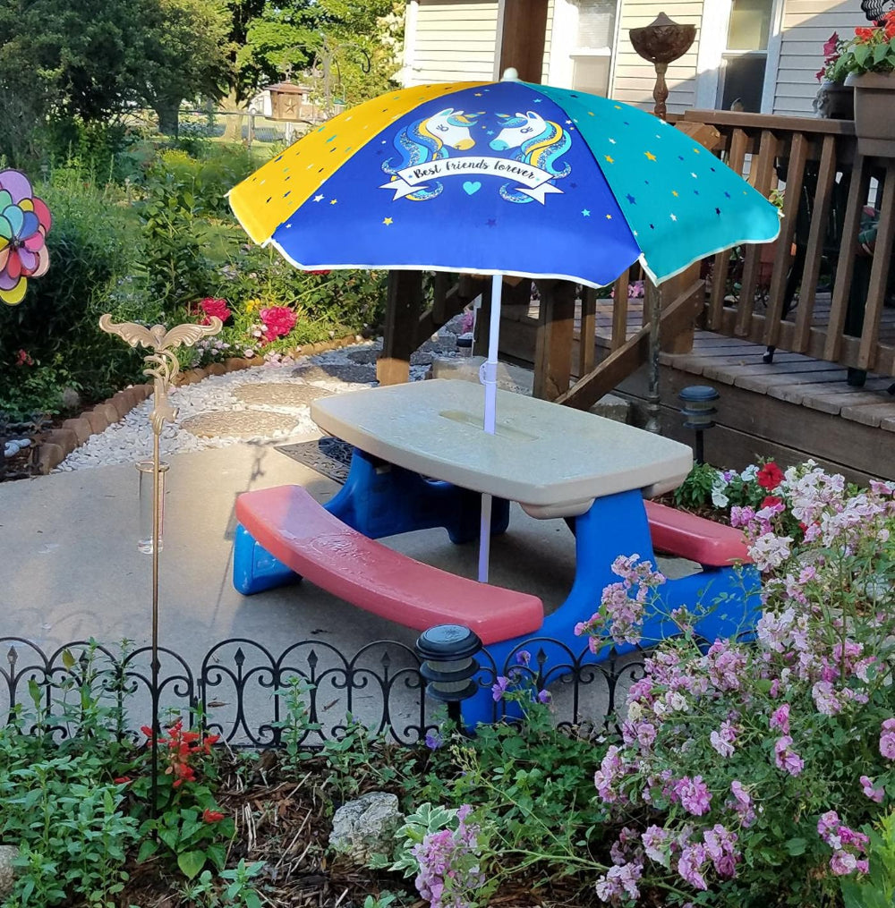 A vibrant AMMSUN 47inches table umbrellas for kids rests on a white picnic table 