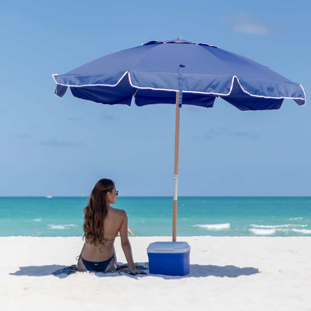 A woman enjoys a serene moment under AMMSUN 7.5ft commercial grade dark blue wood pole umbrella sun