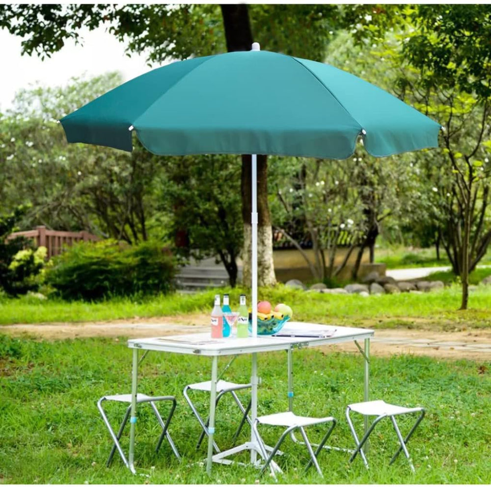 AMMSUN 6FT green outdoor table umbrella is opened and positioned on a white table on grass