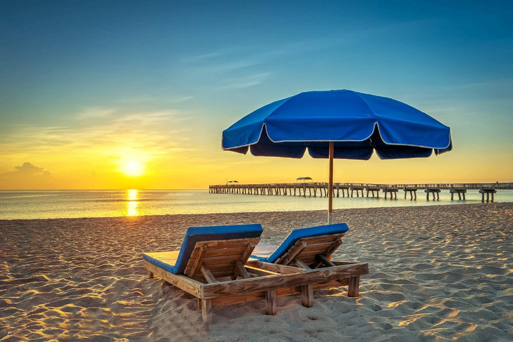 A serene beach sunset featuring two chairs under AMMSUN 7.5ft Commercial Grade blue beach umbrella for chair