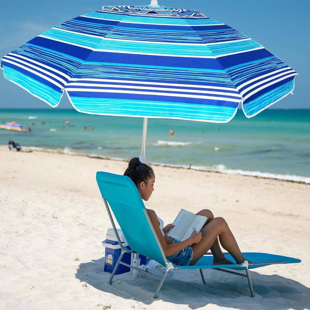 A girl is sitting on a chair beneath AMMSUN 7ft multicolor light blue strips beach umbrella with sand anchor