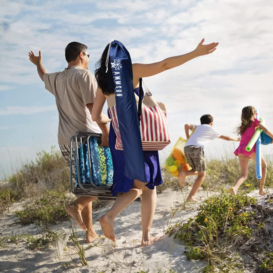 A family of four strolls along the beach, carrying AMMSUN 6.5ft dark blue portable umbrella for beach in a bag