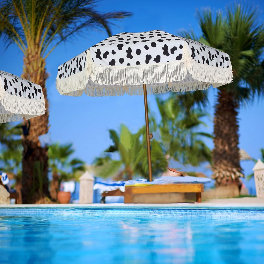 Two AMMSUN 7ft polka-dotted fringe pool umbrellas for inside of pool positioned beside a sparkling pool