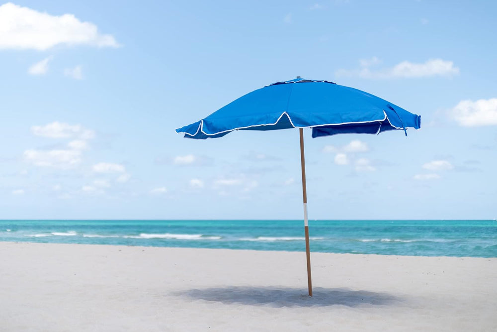 AMMSUN 7.5ft Blue Commercial Grade beach umbrellas for sand is standing on the beach sand