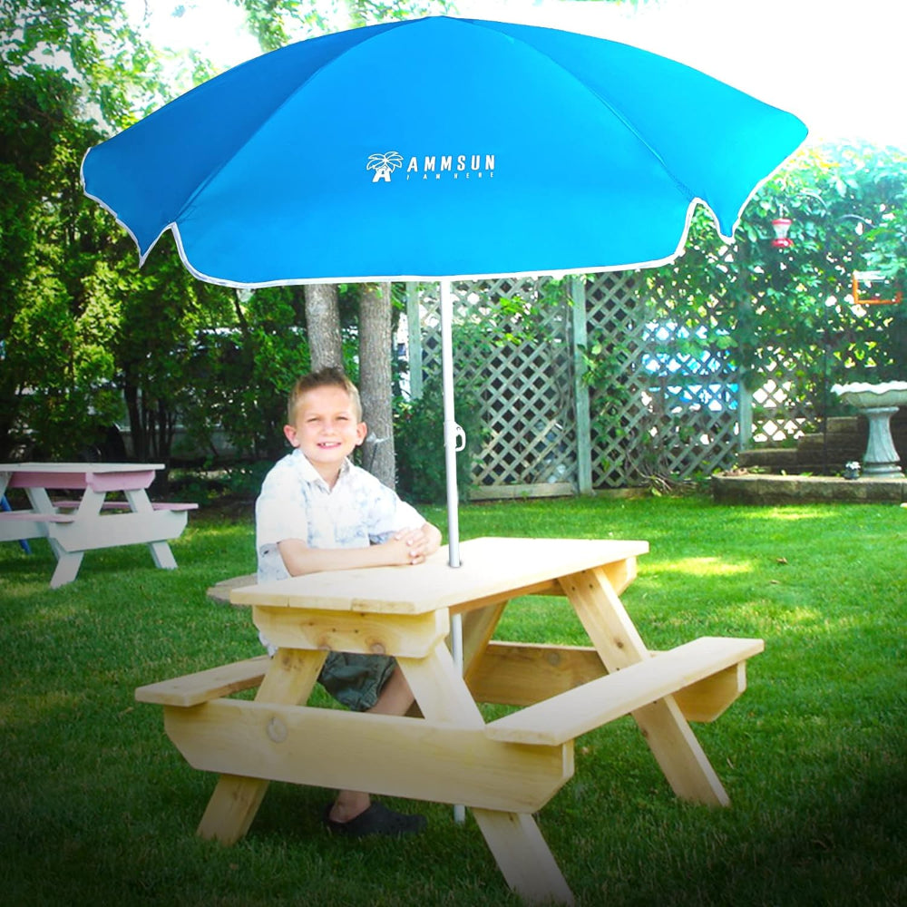 A boy relaxes on kids outdoor picnic table with umbrella AMMSUN 5ft Kid umbrella water table, Sky Blue kids outdoor umbrella