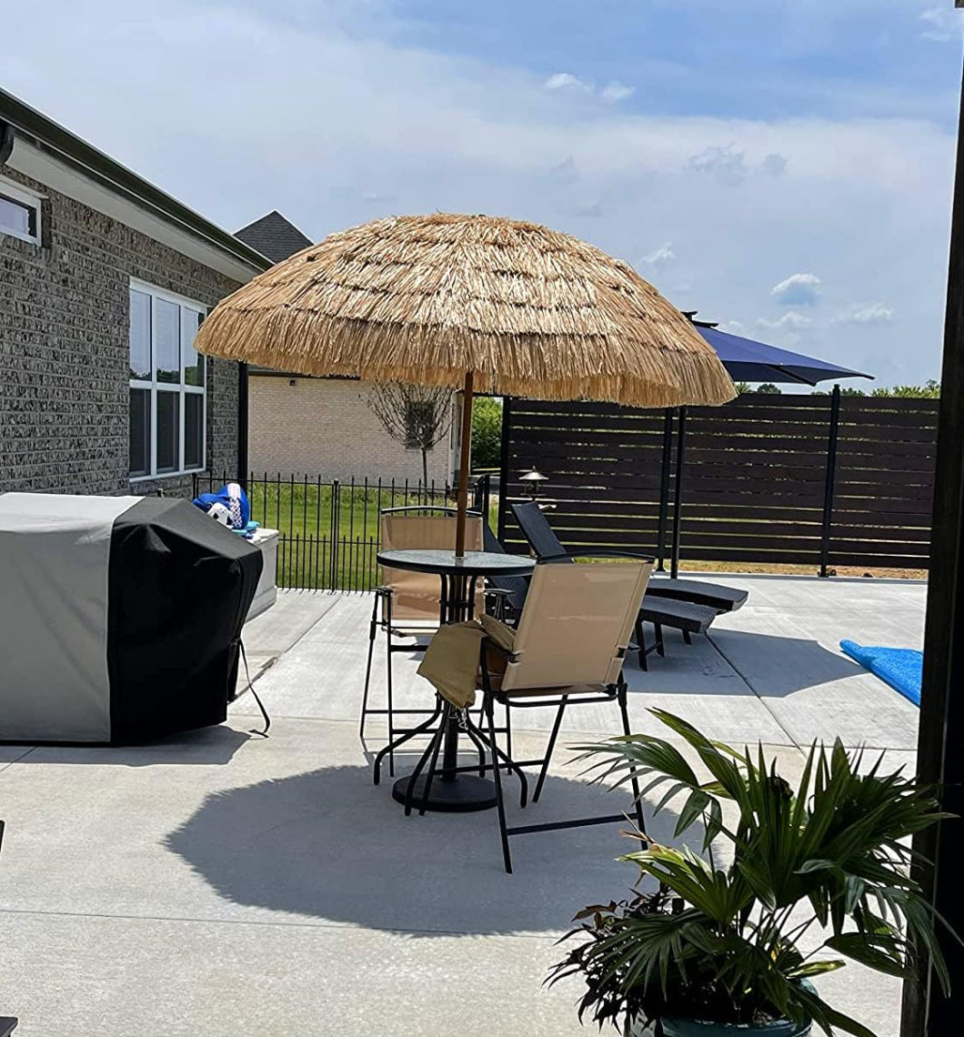 A charming patio showcasing a table and chairs under AMMSUN 7.5ft hula thatched tiki heavy duty beach umbrella