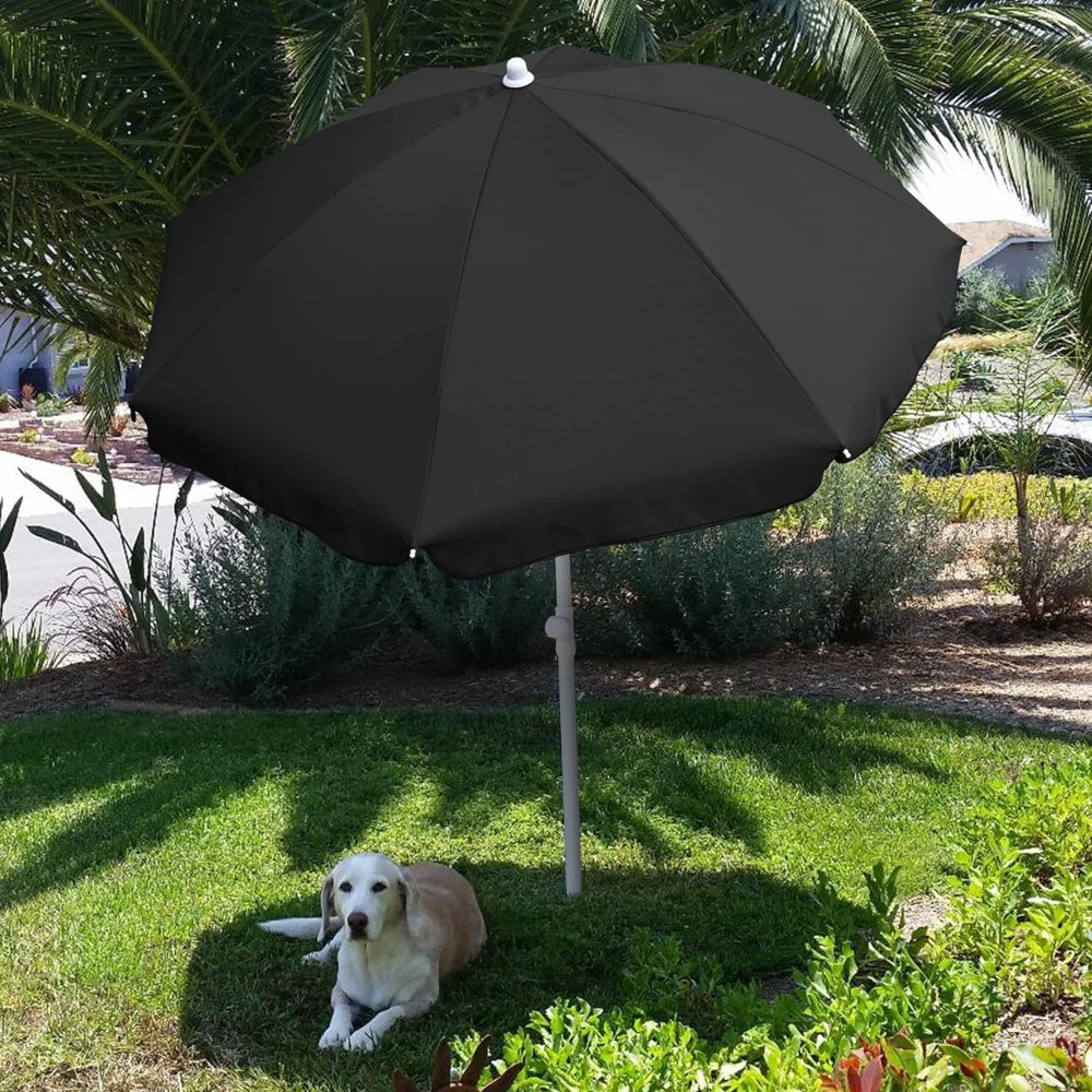 A dog resting under AMMSUN 6ft black sun umbrellas for umbrella outdoor patio on a grassy area