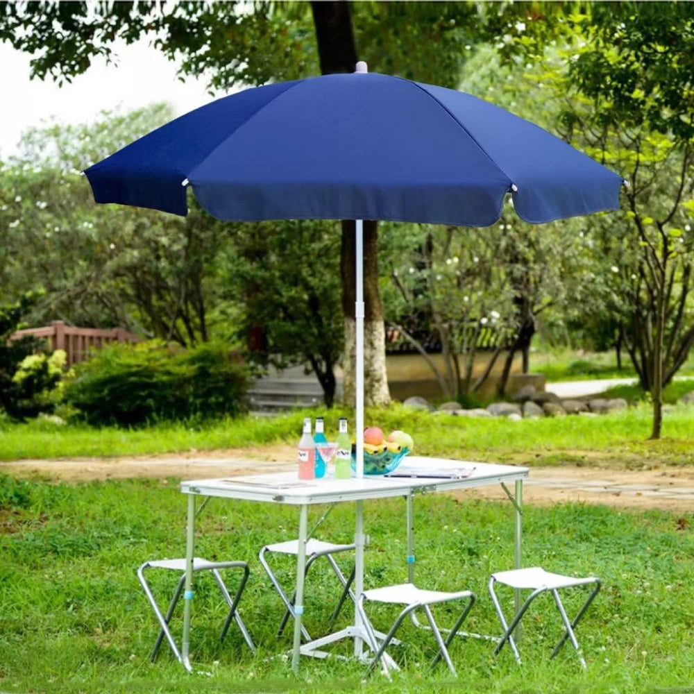 Blue AMMSUN portable shade umbrella stands upright on a table, creating a cheerful atmosphere