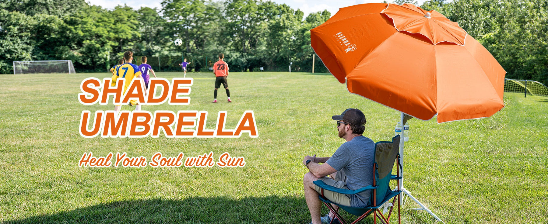 A man sitting under AMMSUN 6.5ft orange  sports umbrella portable umbrella with stand for sport games